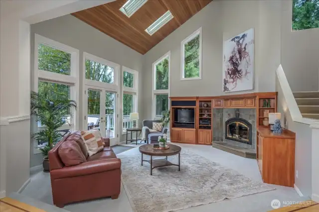 The gathering room boasts a tall vaulted cedar lined ceiling with skylights and cherry built ins.