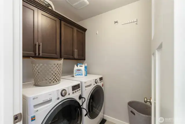 Upstairs laundry room with cabinet storage