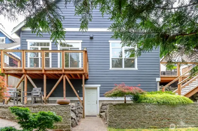 Back of Home - West side, Showing Basement Entry & Deck Off Primary Bedroom