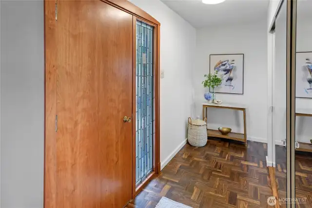 Entry with custom stained glass side panel and look at those beautiful hardwood floors!