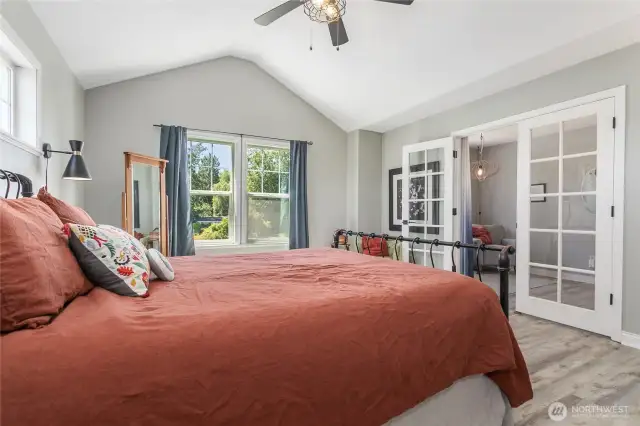 Primary bedroom includes french doors and roomy seating area.