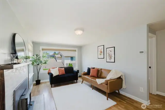 Living room offers abundant light and a wood-burning stove
