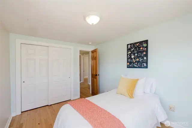 Bedroom one with ample natural light and closet space.