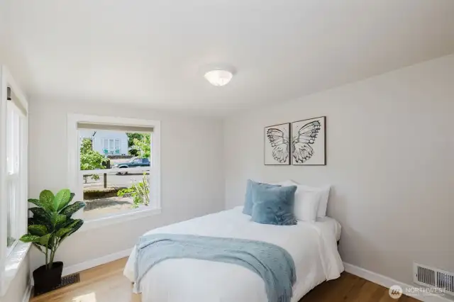 Cozy bedroom two with large windows and closet.