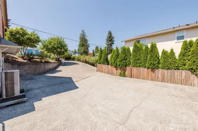 Large driveway with plenty of parking for multiple vehicles.