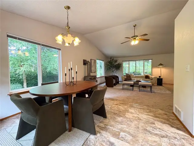 Dining area opens seamlessly into the vaulted living room—perfect for gatherings and everyday living.