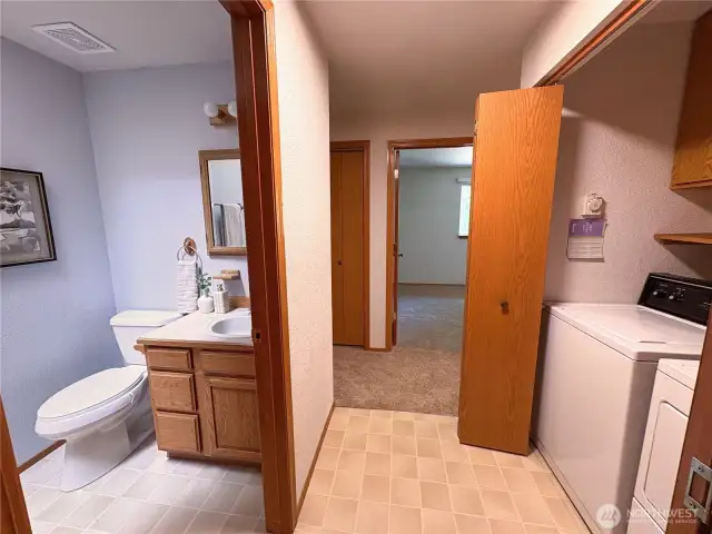 Hall bath with natural light from skylight, positioned across from the laundry room.