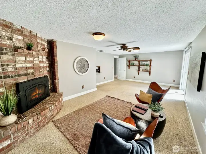 Another view of family room and fireplace.