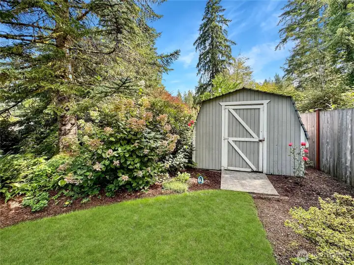 Ample storage shed at back of property, ideal for lawn equipment and patio furniture.
