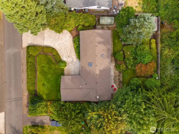 Top-down view of home and property shows greenhouse to the side of home, additional storage shed at the back of property.