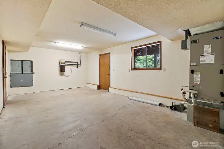 Open utility area with window and exterior access to back yard.