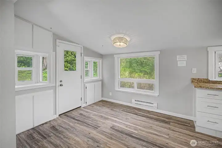 Dining room with back door to the side of the house...just outside is a wood burning firepit