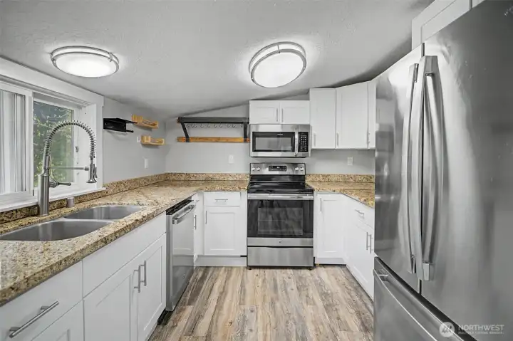 Granite countertops and stainless steel appliances give you a fresh updated kitchen