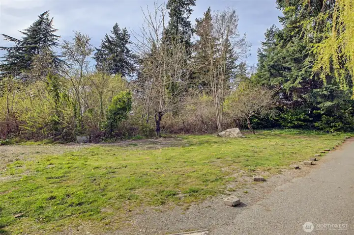 Different view of vacant land on the opposite side of the gravel easement/shared driveway. DADU, shop??