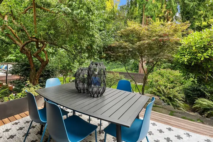 One of two decks engulfed by the verdant green of the backyard