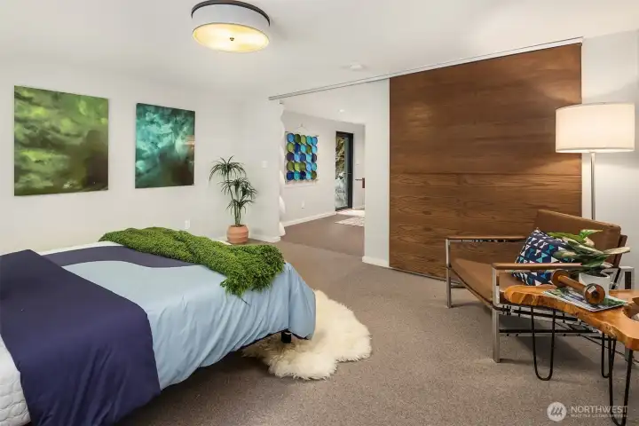 Sleek sliding barn door between bedroom and living space to maximize space