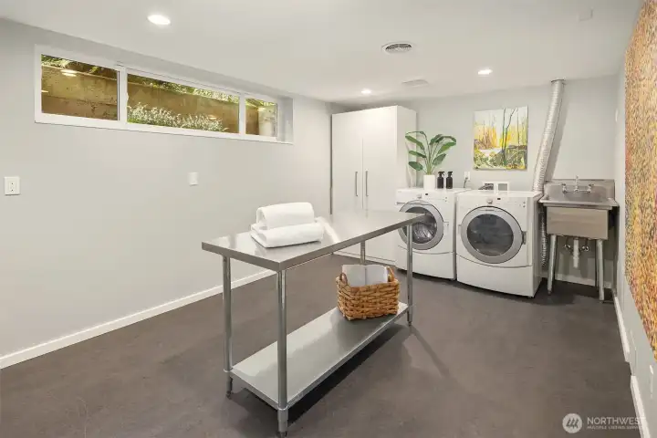 HUGE laundry room with utility sink