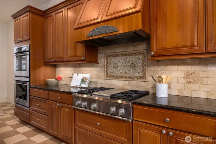 Spacious chef's kitchen with ornate tin ceiling.