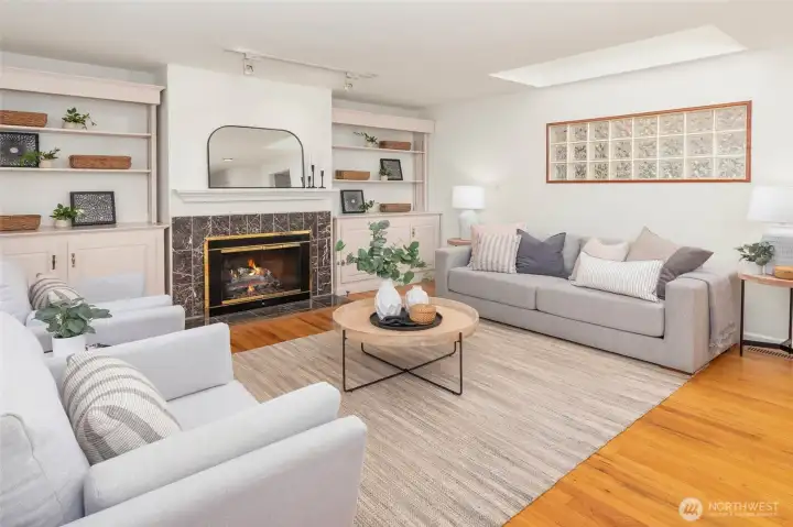 Enter into one of two living spaces, this one complete with fireplace and built-ins.