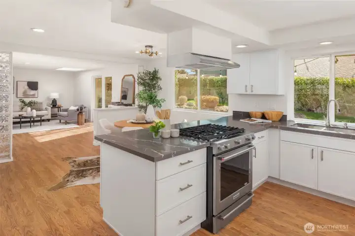 Enter into the kitchen and adjacent dining and second living spaces.