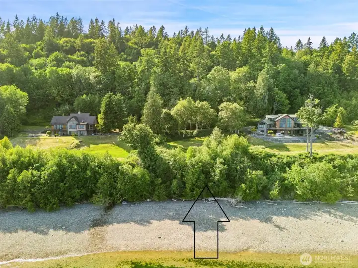 Large waterfront lot sitting in between two custom homes in a gated commmunity.