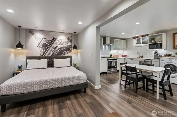 Studio styled ADU with queen sized bed. Across from bed is a sofa, coffee table and TV.