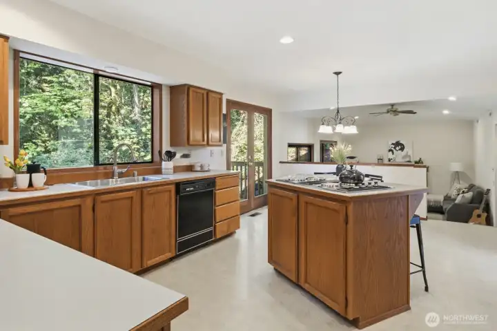 From the kitchen and second dining area, French doors lead out to expansive decking overlooking the tranquil greenbelt.