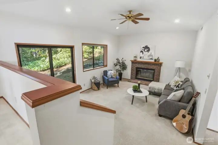 Just off the kitchen, the family room features a cozy wood-burning fireplace, and slider to back patio