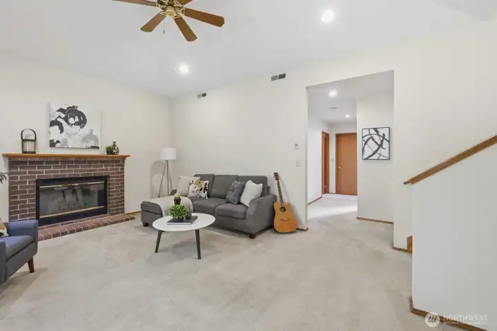 From this living room, you can access the utility room, a bathroom, and a bedroom that also works beautifully as a den, office, or home gym.