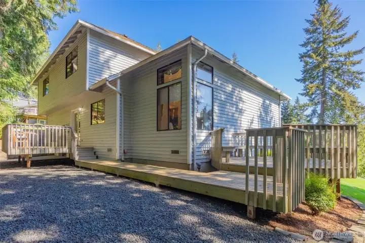 Expansive decking along the back of the home transitions beautifully to a circular patio deck.