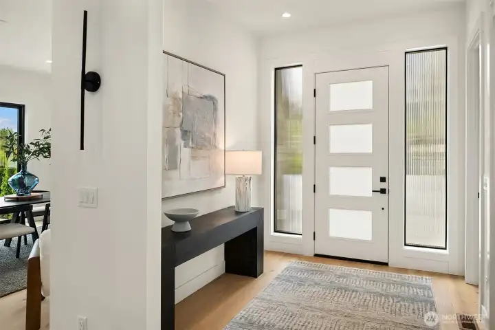 Experience luxury with 10-foot ceilings that enhance the entryway, providing a bright and inviting atmosphere throughout the home.