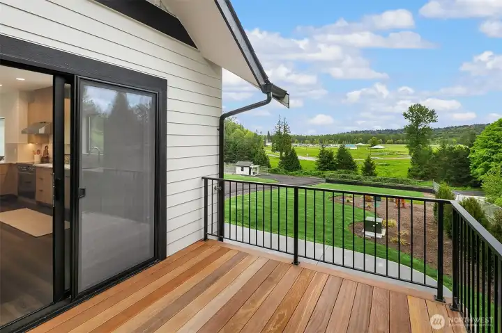 Deck off ADU  A standout feature, the ADU deck offers privacy and an outdoor water spigot, ideal for gardening or outdoor activities.