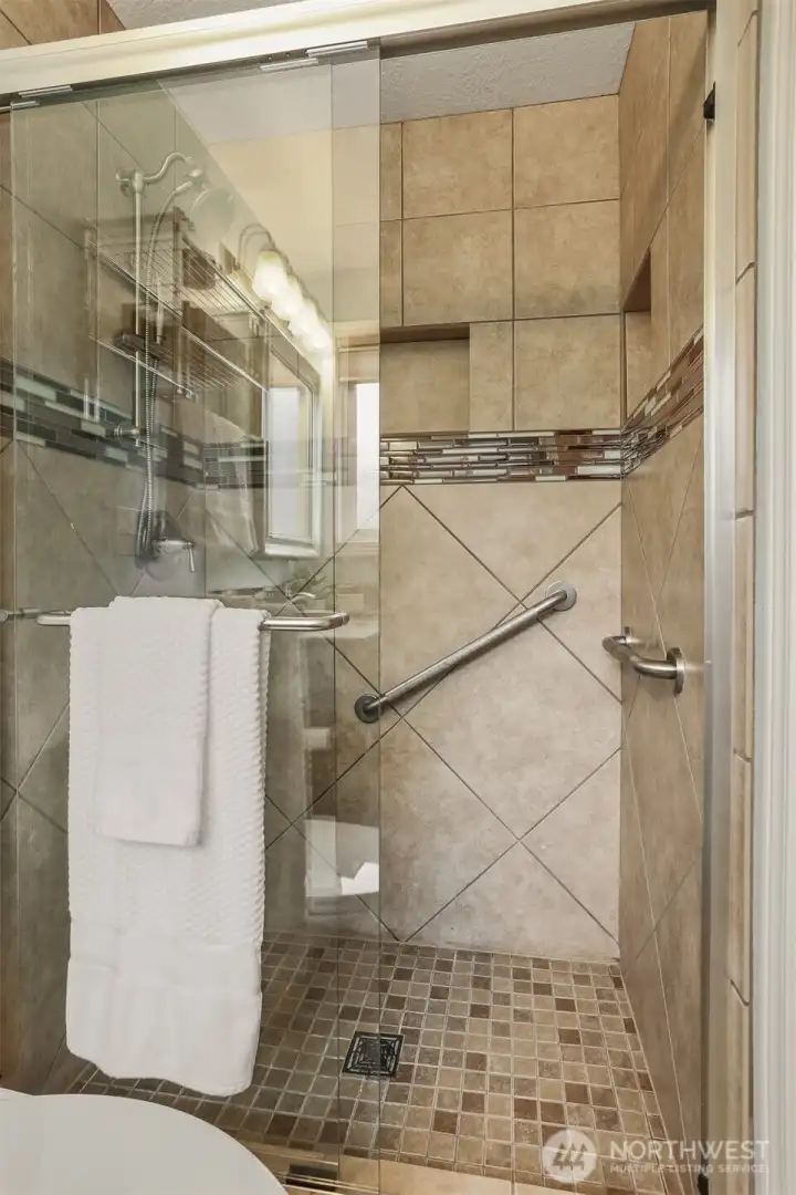 The shower in the primary bathroom has grip bars.