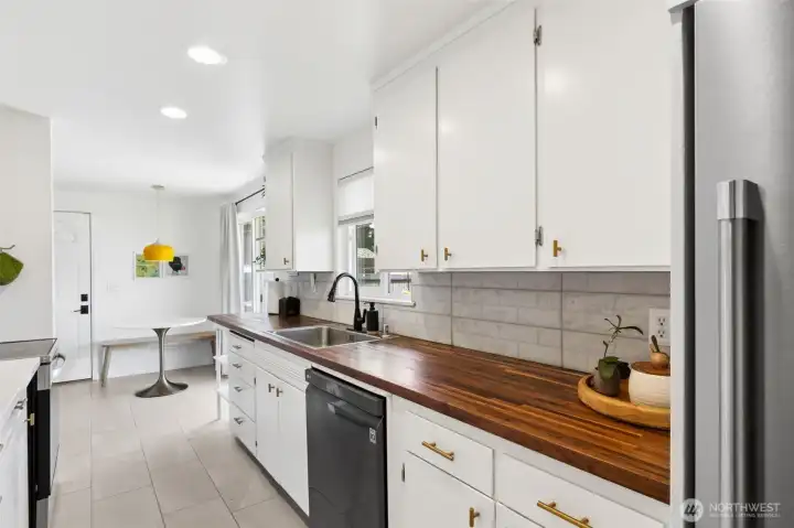 The kitchen has beautiful butcher block counters.