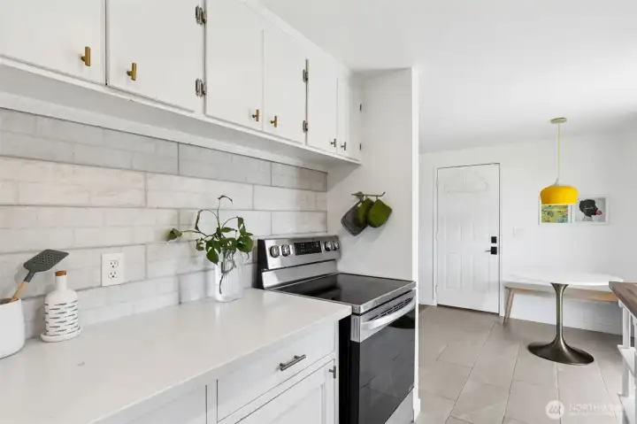 Ceramic tile floors in the kitchen and stainless steel appliances.