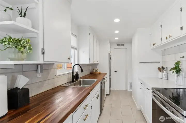 The pantry is at the end of the kitchen, super convenient!