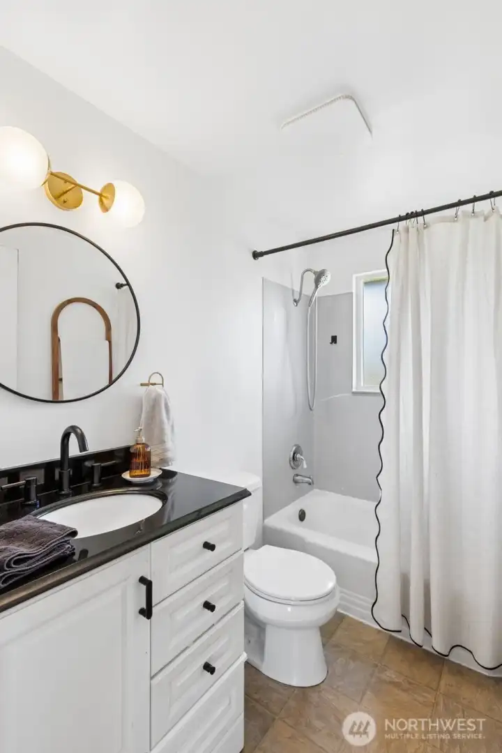The bathroom has an updated vanity and lighting fixtures.