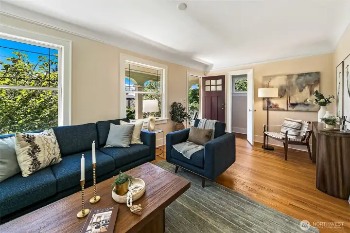Spacious living room with coved ceilings, original hardwood floors and upgraded windows. Spacious living room with coved ceilings, original hardwood floors and upgraded windows.