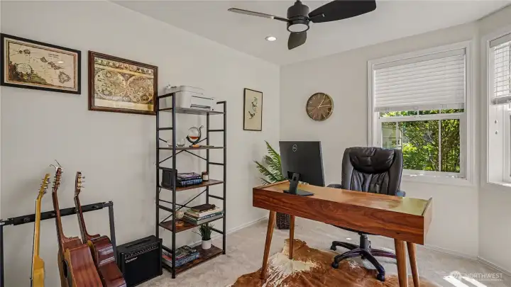 Main floor den with ceiling fan & over head lighting - installed by seller and unique to this unit!
