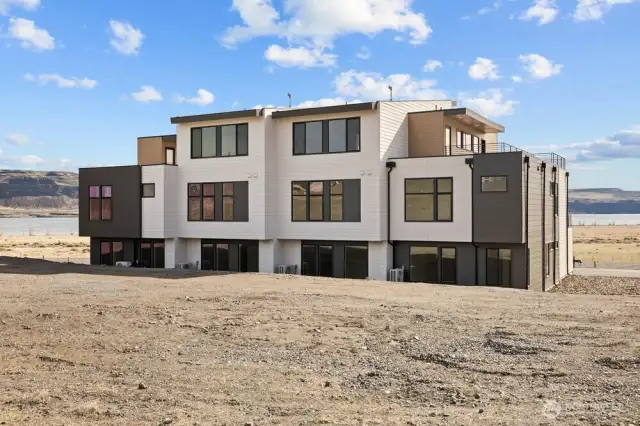 Gorgeous townhomes featuring expansive windows, ample parking, and multiple outdoor decks.
