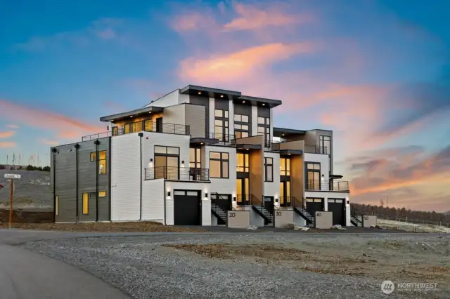 Gorgeous townhomes featuring expansive windows, ample parking, and multiple outdoor decks.