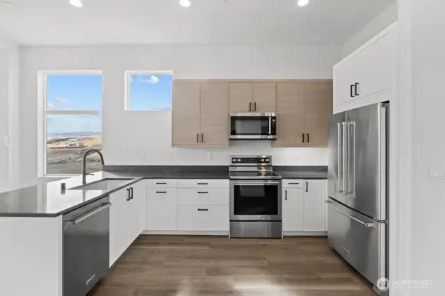 Bright, open kitchen with convenient bar seating.