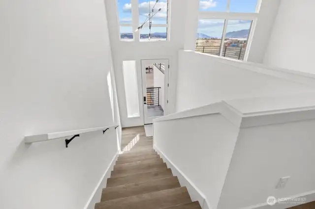 Oversized windows flood the space with natural light and endless blue sky views.