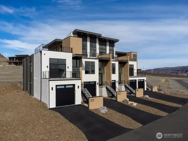 Gorgeous townhomes featuring expansive windows, ample parking, and multiple outdoor decks.