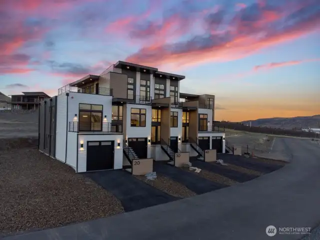 Gorgeous townhomes featuring expansive windows, ample parking, and multiple outdoor decks.