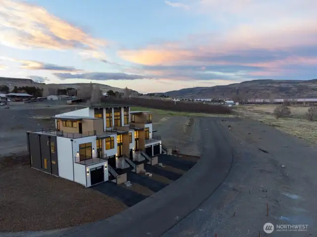 Gorgeous townhomes featuring expansive windows, ample parking, and multiple outdoor decks.