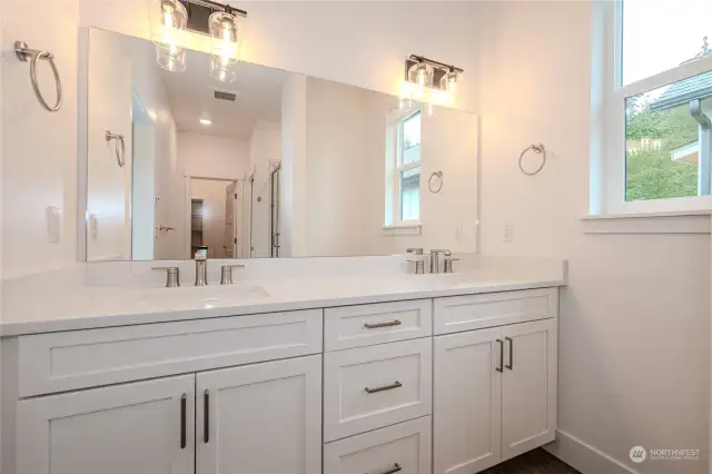 Prepare to be captivated by the dreamy Primary Bathroom! Revel in the expansive mirror, dual sink vanity boasting fabulous storage and stunning quartz counters. The touch of a dial directs warm air out from a vent below the vanity to keep your toes nice and toasty.