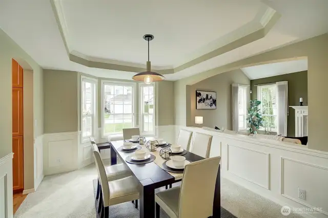 The dining room is elegant with a coffered ceiling and wainscoting add a touch of sophistication for your dinner gatherings.