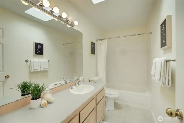 Adjacent to the upstairs bedroom is another full-sized bath.