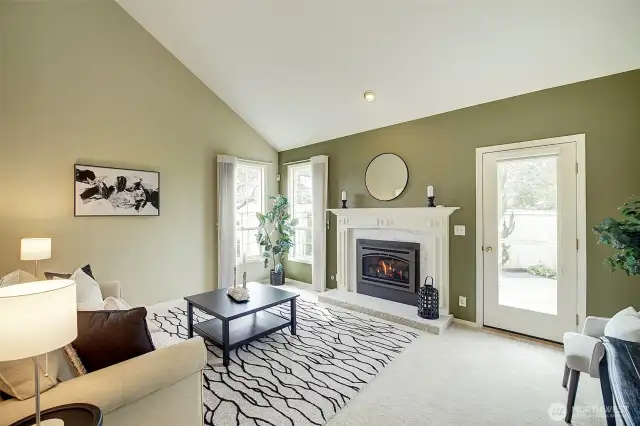 The light-filled living room features a cozy gas fireplace, perfect for those relaxing evenings.